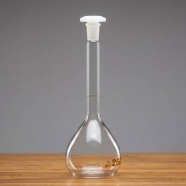 A Class A 250ml clear borosilicate glass volumetric flask with a white polyethylene (PE) stopper and a single graduation mark for precise liquid measurement.