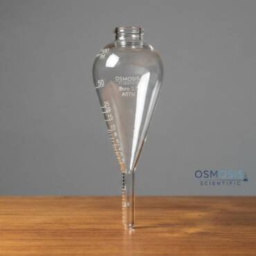 A 100ml pear-shaped centrifuge tube made of clear borosilicate glass with ASTM graduation markings and a conical bottom for sediment separation.