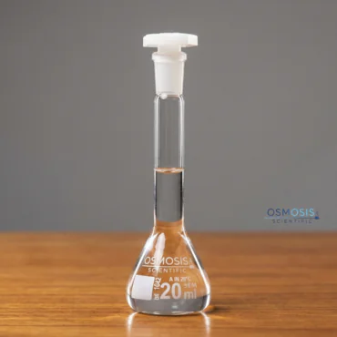 Clear glass trapezoidal volumetric flask for precise laboratory measurements