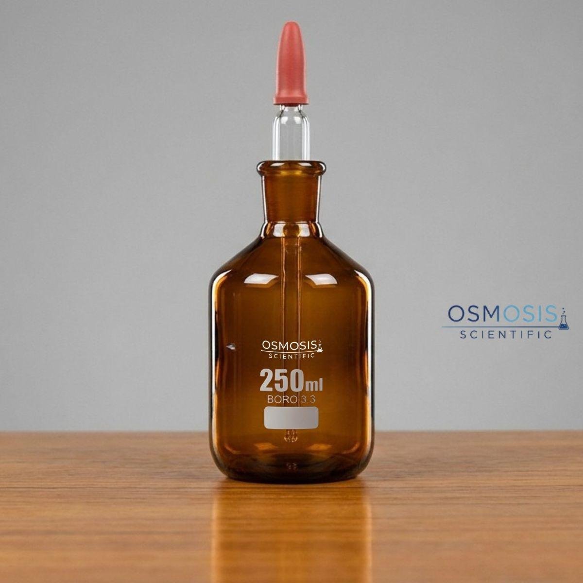 A 250ml amber borosilicate glass dropping bottle with a ground glass stopper featuring an integrated pipette and a red rubber bulb for dispensing light-sensitive liquids.