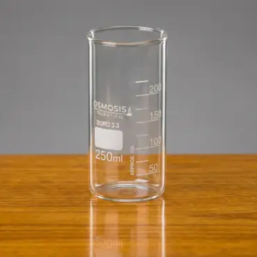 Osmosis Scientific 250ml Berzelius tall form beaker made of Borosilicate 3.3 glass without a spout, featuring white volume graduations on a wooden surface.
