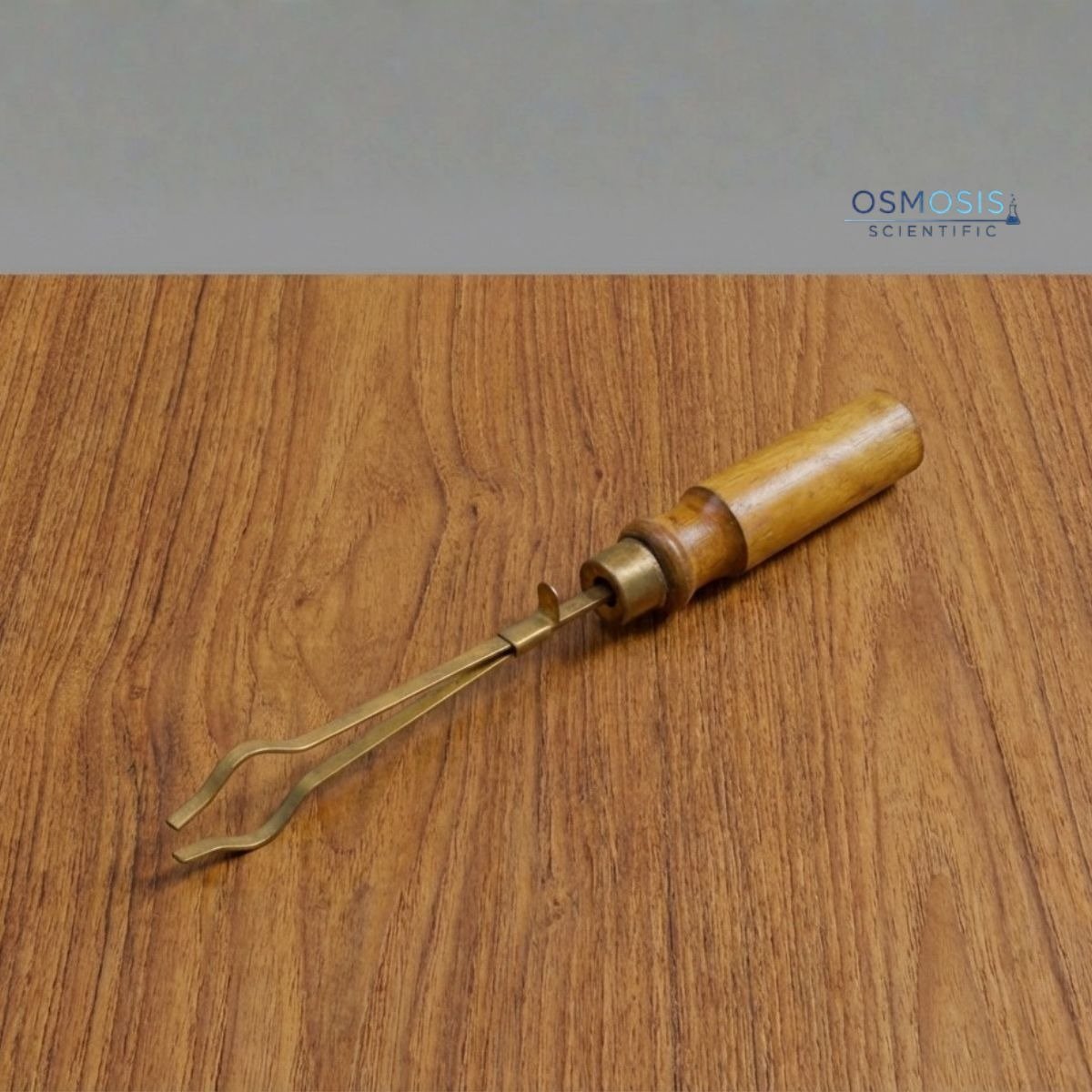 Brass test tube holder with wooden handle for laboratory heating and safe handling