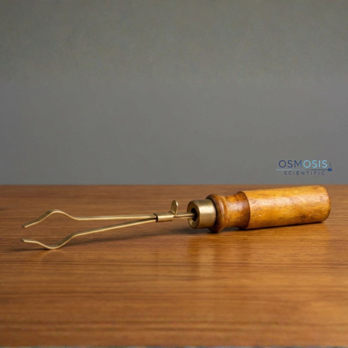 Brass test tube holder with wooden handle for laboratory heating and safe handling