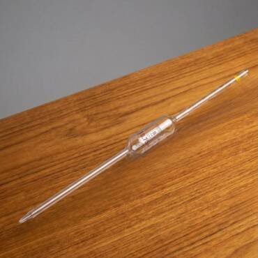 A Class A 10.75ml milk pipette made of clear borosilicate glass with NABL calibration markings, designed for accurate milk fat testing.