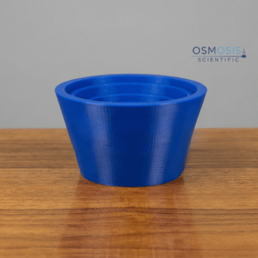 A blue rubber crucible holder with a tiered internal design and the Osmosis Scientific logo, shown on a wooden surface.
