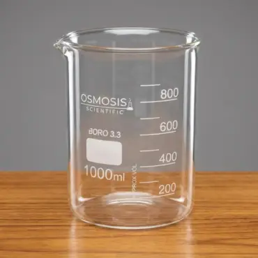 Osmosis Scientific 1000ml Tablet Disintegration Test Beaker made of Borosilicate 3.3 glass with a pouring spout and white volume graduations on a wooden surface.