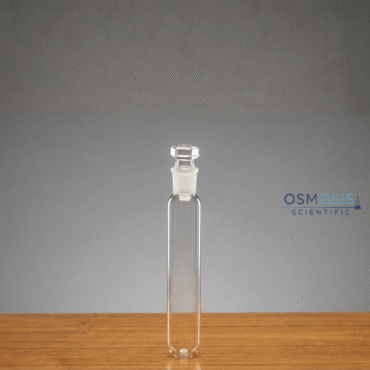 A clear borosilicate glass test tube with a rounded bottom and a precision-ground interchangeable glass stopper.